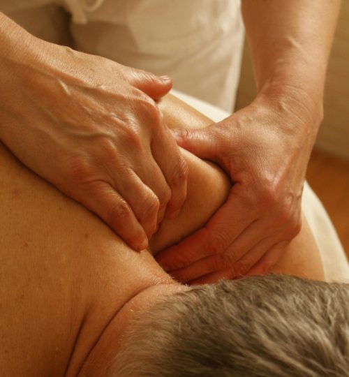 Close-up of a therapist giving a relaxing shoulder massage, enhancing wellness and stress relief.