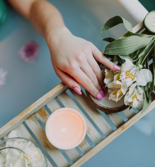 Elegant spa setting with flowers, bath salts, and calming ambiance for ultimate relaxation.